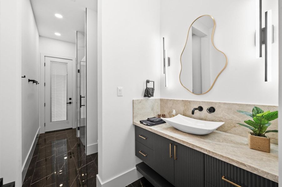Secondary full bathroom offers modern finishes and designer-selected fixtures.