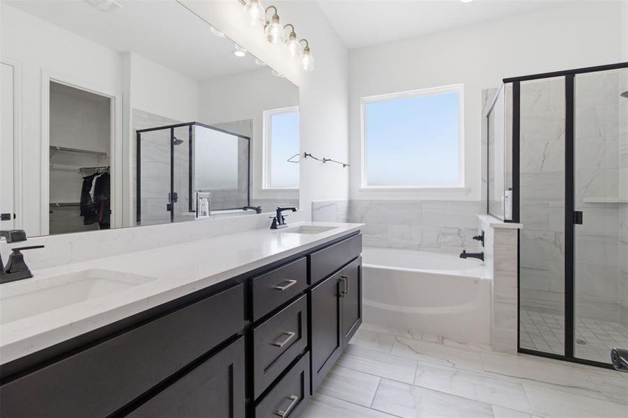 Double vanity with dark wood-finish cabinetry and white countertops