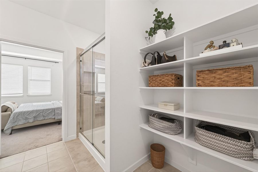 Linen cabinet is conveniently situated in the primary bath, it's expansive shelving can hold and store numerous items.