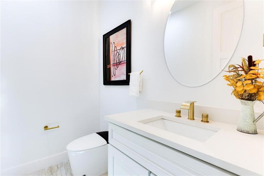 Bathroom featuring vanity and toilet