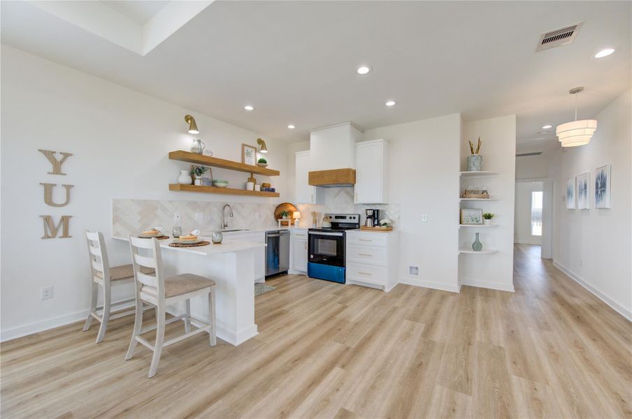 Open-concept layout combining kitchen, dining, and living areas