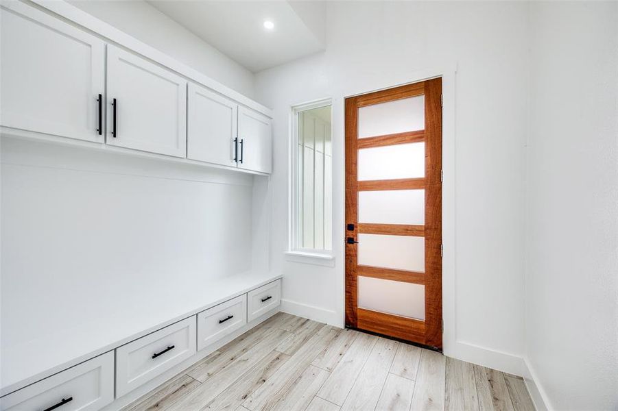 Mudroom featuring light wood-style floors and baseboards Mudroom featuring light wood-style floors and baseboards
