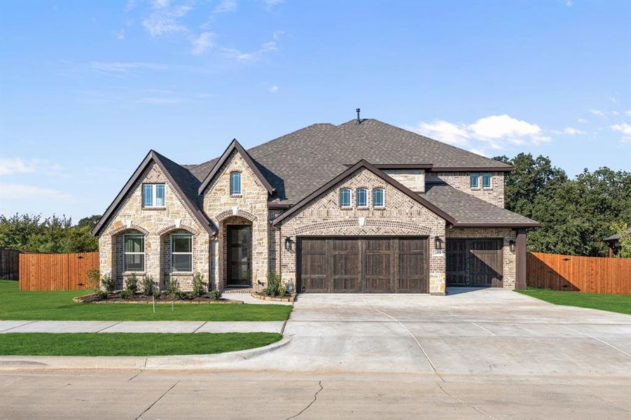 Front exterior of a new home in Triple Diamond Ranch, Mansfield, TX, highlighting curb appeal (Image 2). Front exterior of a new home in Triple Diamond Ranch, Mansfield, TX, highlighting curb appeal (Image 2).