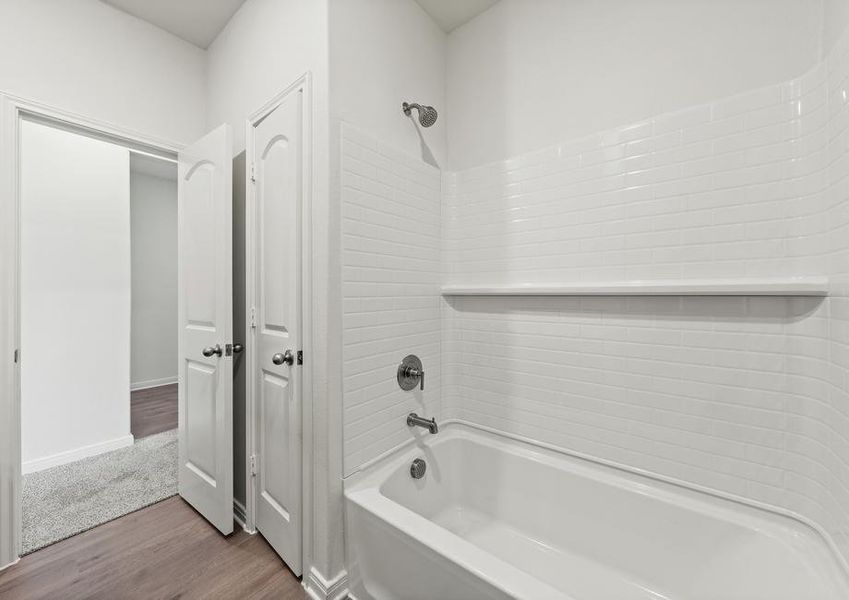 The secondary bathroom has a shower-tub combo.