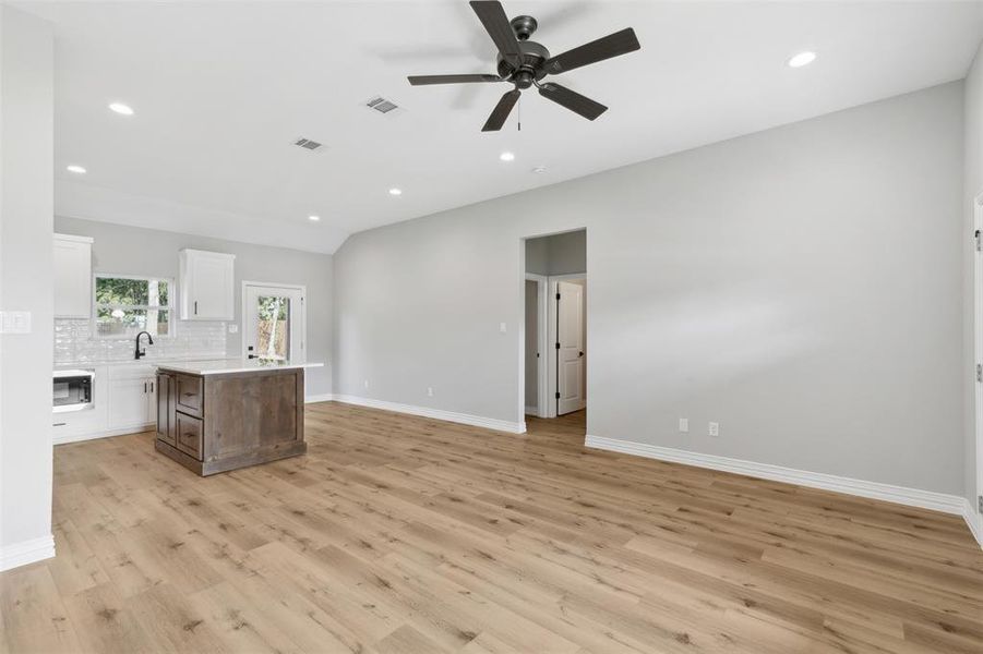 Unfurnished room with ceiling fan and light hardwood / wood-style floors