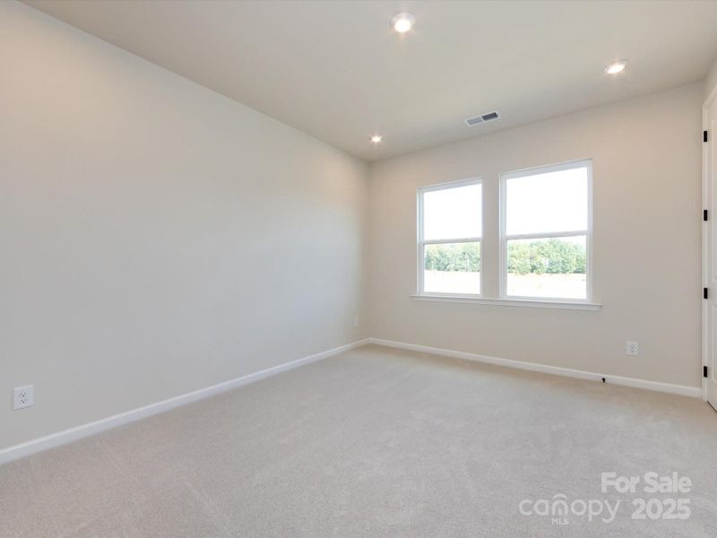 Primary Suite Complete with 9' Ceilings and Bright Windows.