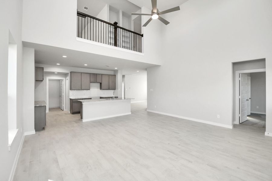 Family room flooded with natural light through the expansive windows. The premium tileflooring adds a touch of luxury to the space, creating the perfect setting for relaxing momentsand cherished gatherings with loved ones. Sample photo of completed home with similar floor plan. Actual colors and selections may vary.