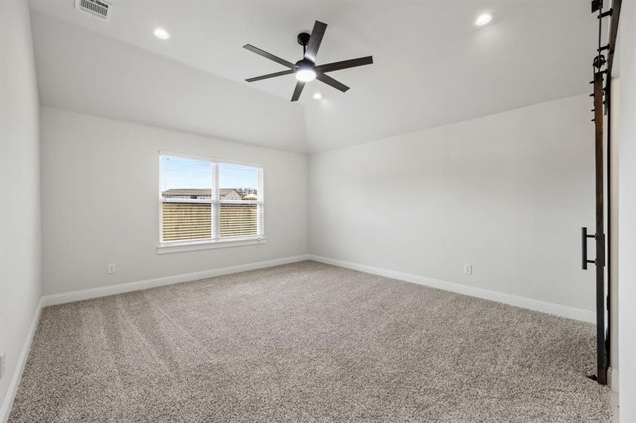 Unfurnished room with light colored carpet, vaulted ceiling, a ceiling fan, and recessed lighting