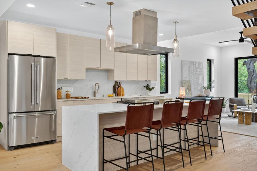 Gas Cooking centered in a large island that easily fits four bar stools. Gas Cooking centered in a large island that easily fits four bar stools.