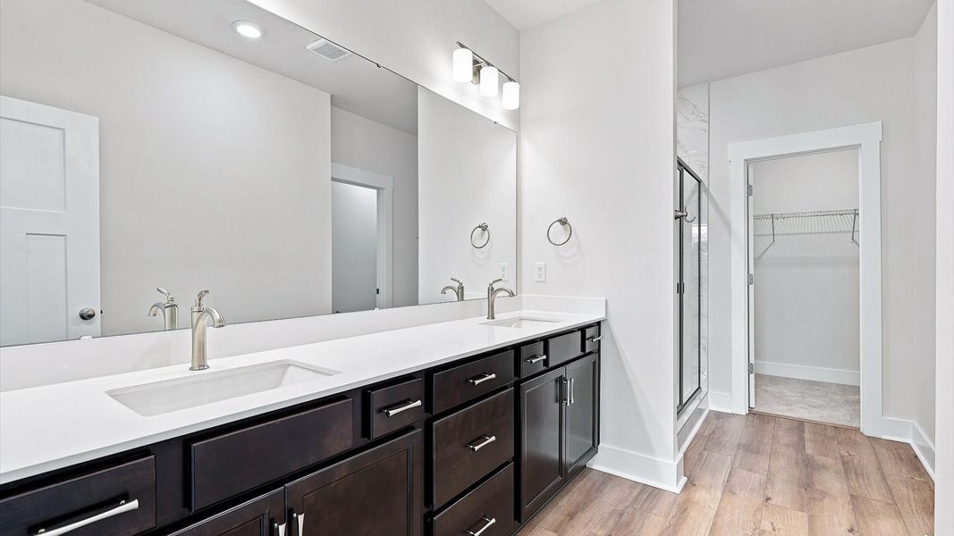 Spacious and modern primary bathroom with walk-in shower and first-class double vanity setup in Anderson, SC