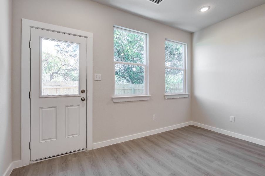 A room with a door and windows. A room with a door and windows.