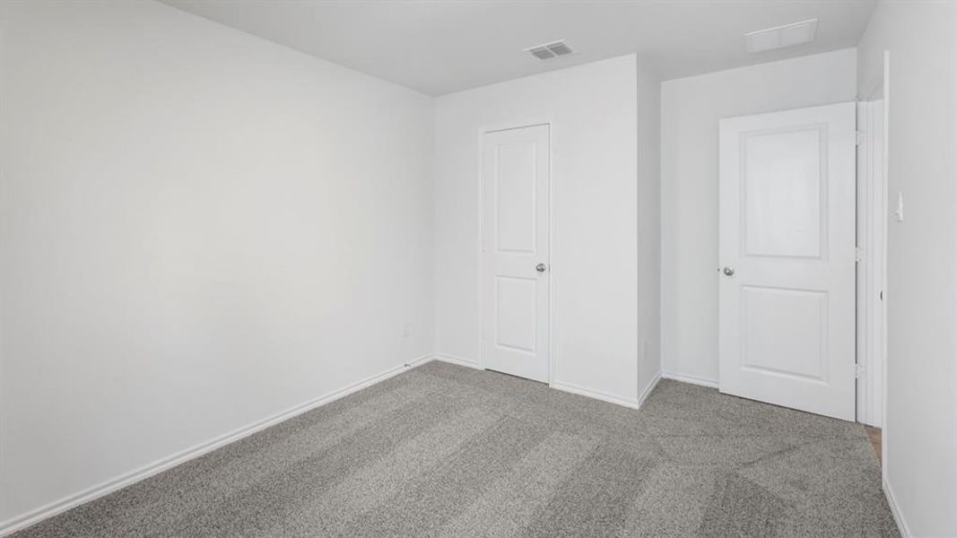 Neutral wall finishes and gray carpet flooring