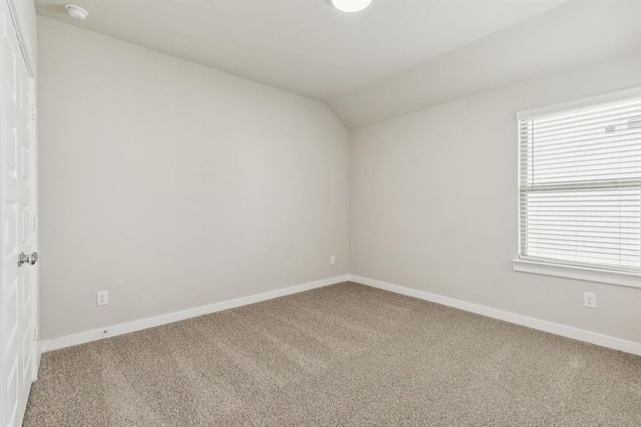 Bedroom in the Heisman home plan by Trophy Signature Homes – REPRESENTATIVE PHOTO