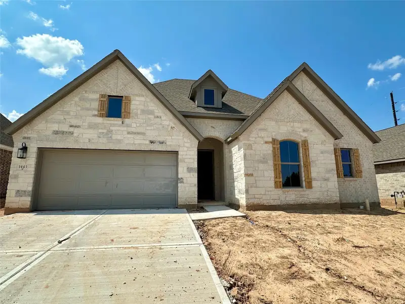 Front exterior of a new home in Escondido, Magnolia, TX, highlighting curb appeal (Image 1).
