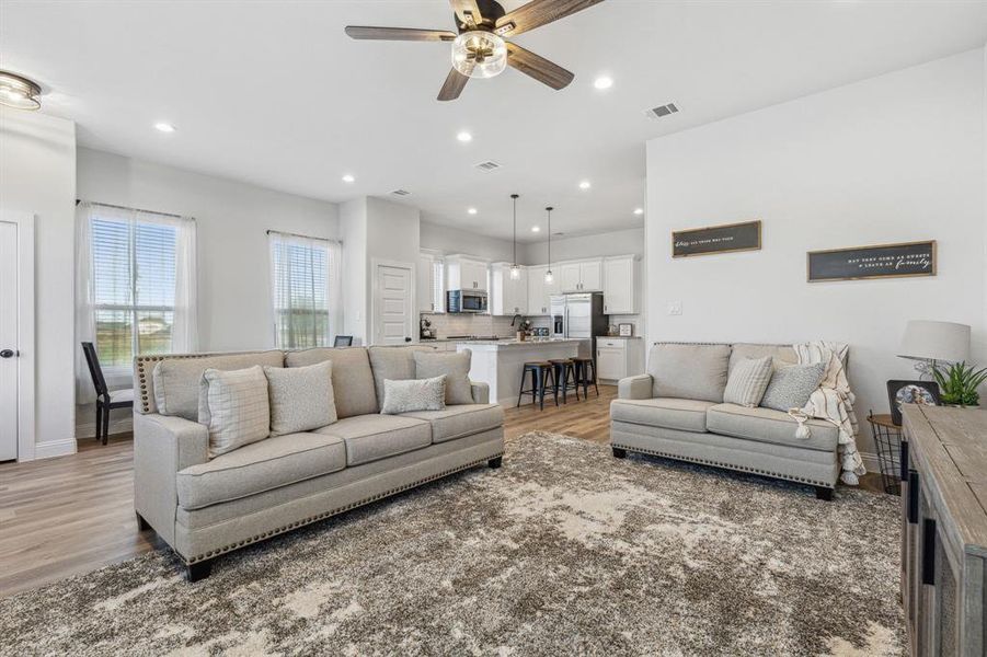 Living room featuring light wood-type flooring and ceiling fan