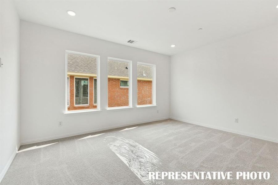 The family fun time continues upstairs in this light filled game room!  REPRESENTATIVE PHOTO
