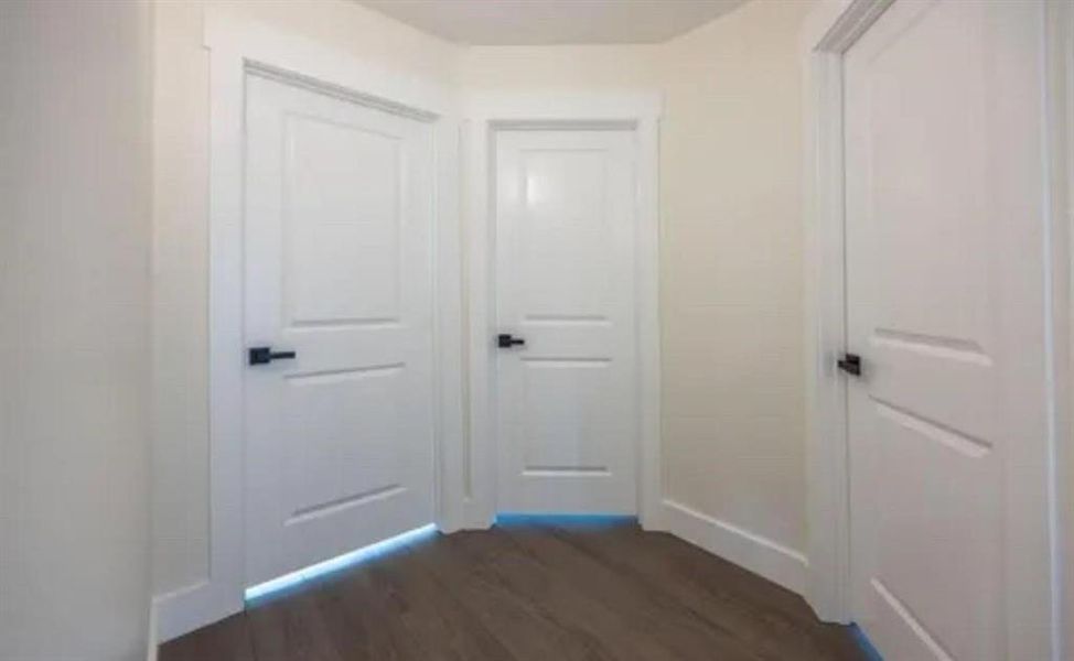 Hallway featuring dark wood-style flooring