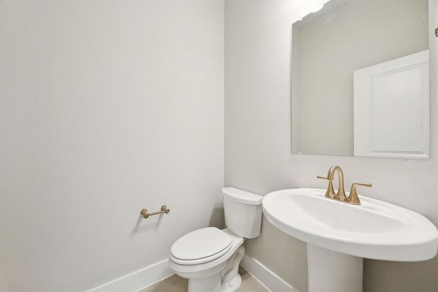 Bathroom featuring toilet and tile patterned floors