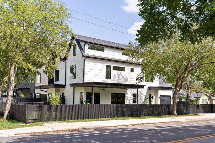 View of front of house featuring a fenced front yard and a ceiling fan