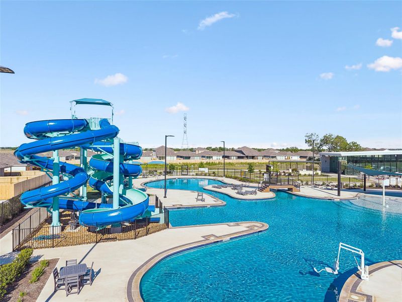 Resort-style aquatic amenity featuring multiple swimming pools, a multi-story water slide, and a splash pad Resort-style aquatic amenity featuring multiple swimming pools, a multi-story water slide, and a splash pad
