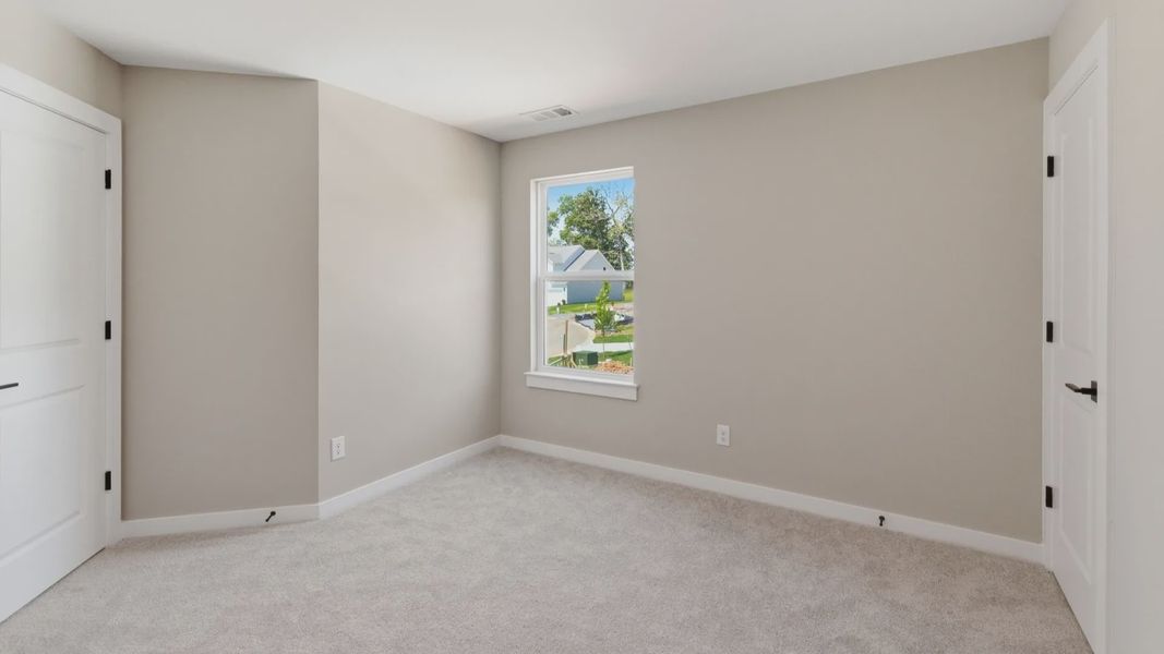 Bedroom with carpet and window