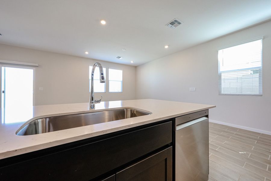A kitchen with a sink and a window. A kitchen with a sink and a window.