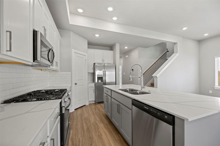 Oversized island provides extra seating and prep space — ideal for family meals or casual entertaining.