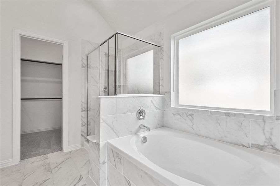 Bathroom featuring independent shower and bath and tile patterned floors