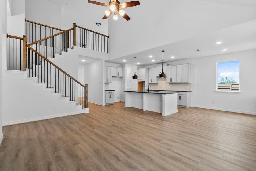 This dramatic two-story living room pairs architectural height with industrial texture and modern comfort. This dramatic two-story living room pairs architectural height with industrial texture and modern comfort.