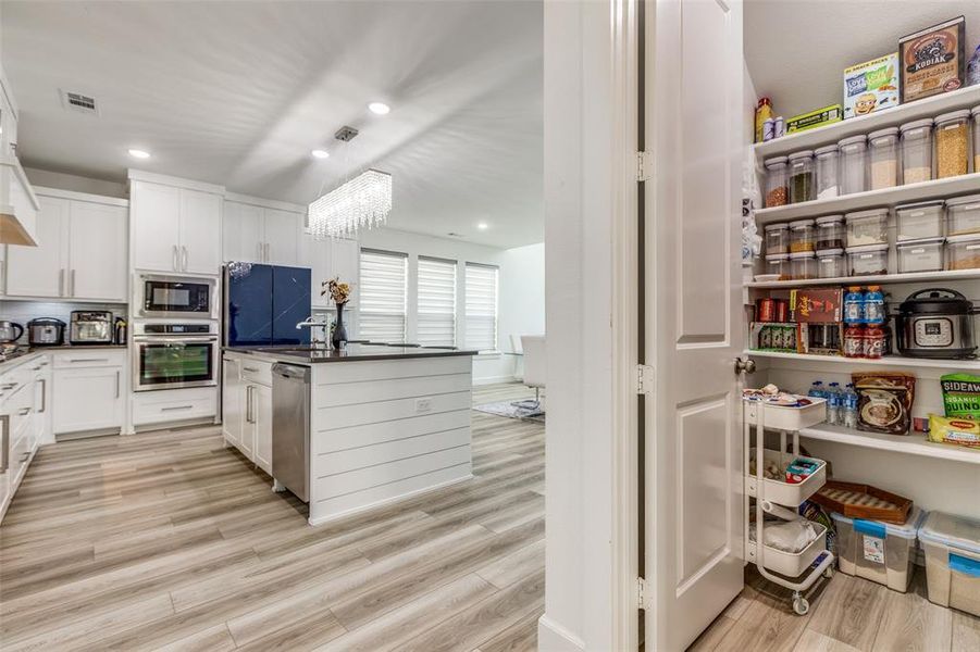 Incredible oversized walk-in pantry complements this stunning luxury kitchen—perfect for staying organized and keeping all your essentials within easy reach! Incredible oversized walk-in pantry complements this stunning luxury kitchen—perfect for staying organized and keeping all your essentials within easy reach!
