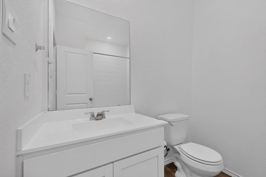 Clean lines and a crisp white vanity define this streamlined powder room. Clean lines and a crisp white vanity define this streamlined powder room.