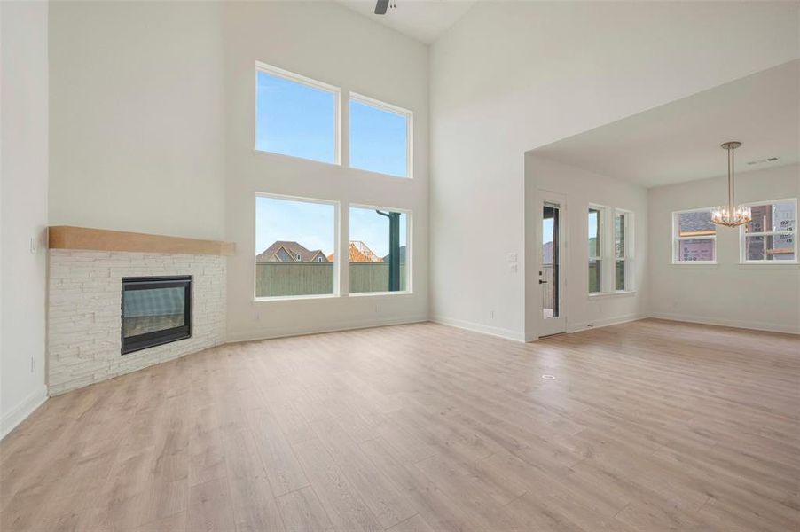 Spacious living area featuring a vaulted ceiling and wood-finish flooring