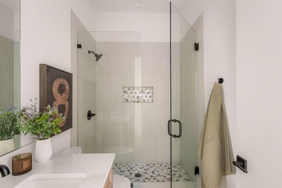 Bathroom featuring a stall shower and vanity Bathroom featuring a stall shower and vanity