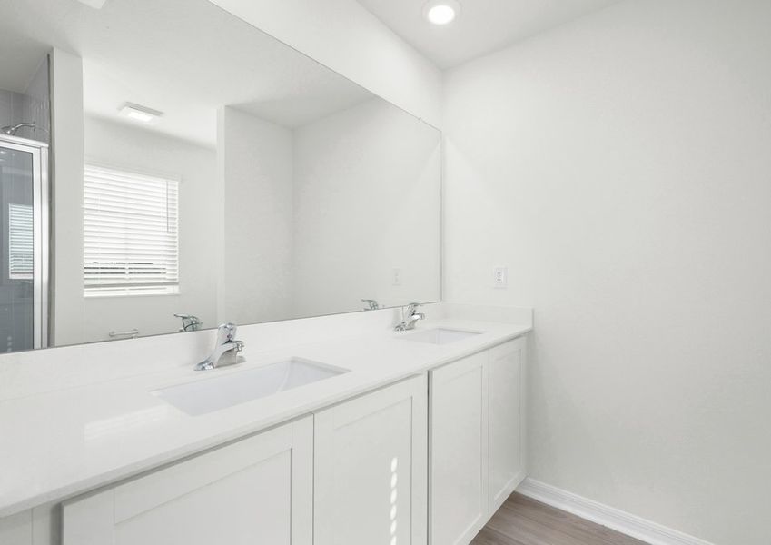 The master bathroom boasts a stunning dual-sink vanity