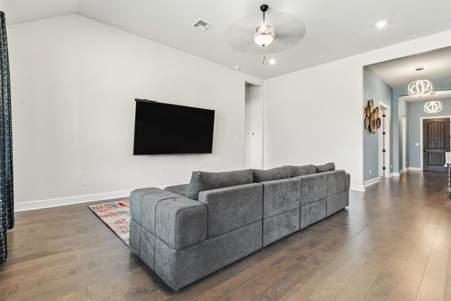 Living area featuring wood finished floors, ceiling fan, and recessed lighting Living area featuring wood finished floors, ceiling fan, and recessed lighting