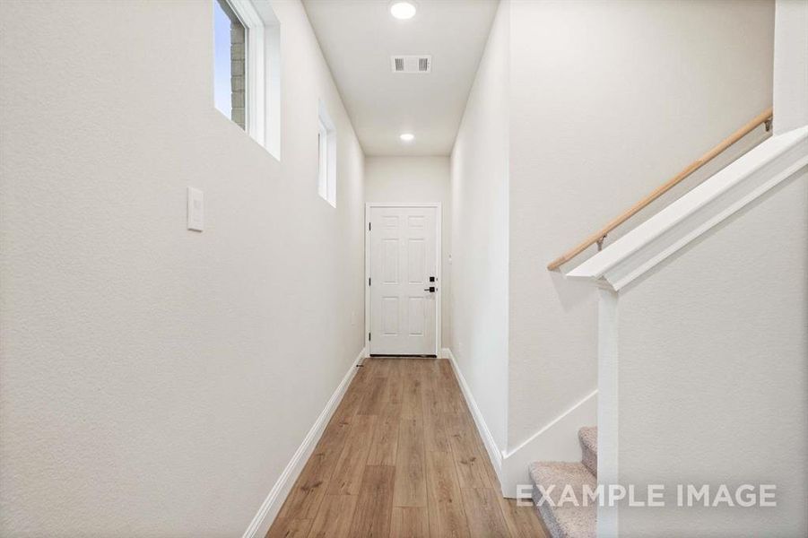 Hall with light hardwood / wood-style flooring