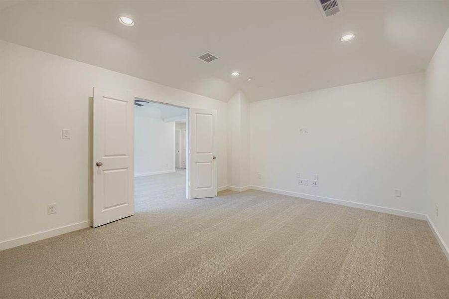 Spare room featuring light colored carpet, recessed lighting, and lofted ceiling Spare room featuring light colored carpet, recessed lighting, and lofted ceiling