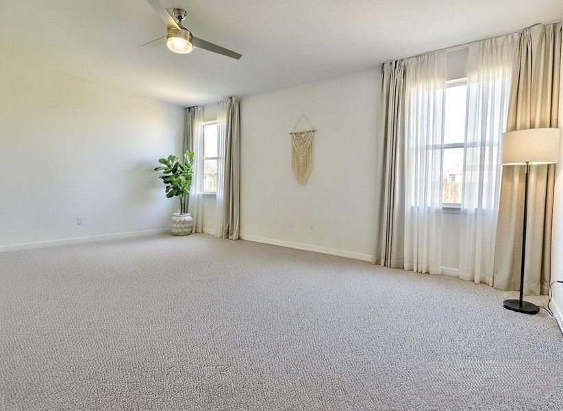 Spare room with carpet flooring and ceiling fan