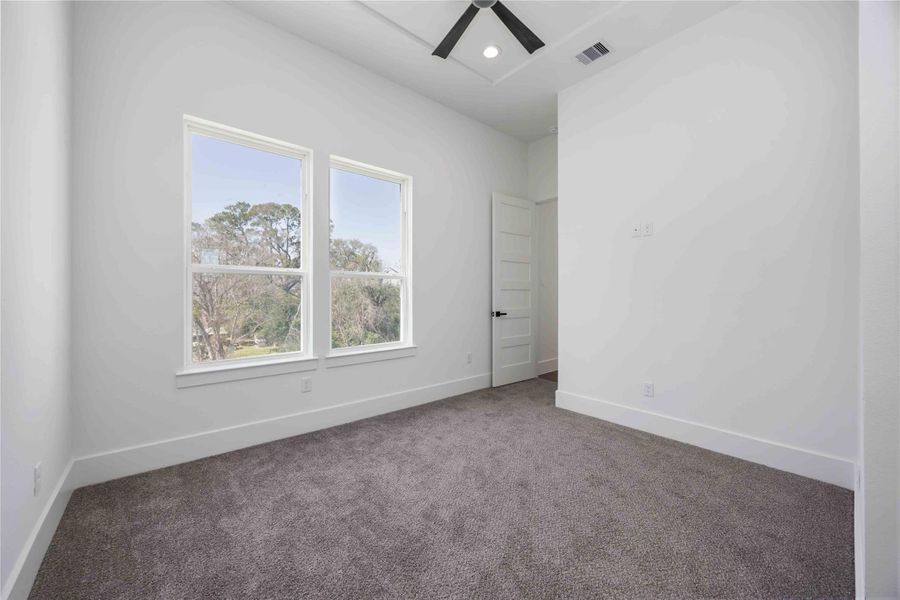 Third-floor secondary bedroom featuring its own en suite bath for convenience and privacy.