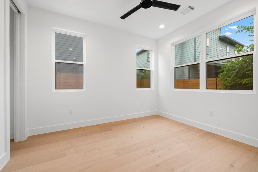 Empty room featuring light wood-type flooring, a ceiling fan, and recessed lighting Empty room featuring light wood-type flooring, a ceiling fan, and recessed lighting