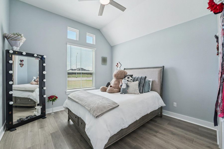 Large windows frame peaceful views of the surrounding property, adding a sense of tranquility.