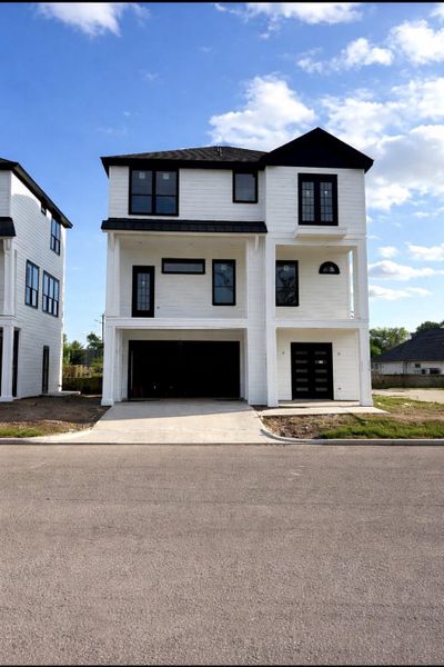 Actual Photo 1 : 1714 Erin Street - An oversized garage with 220V capability ensures true EV readiness.