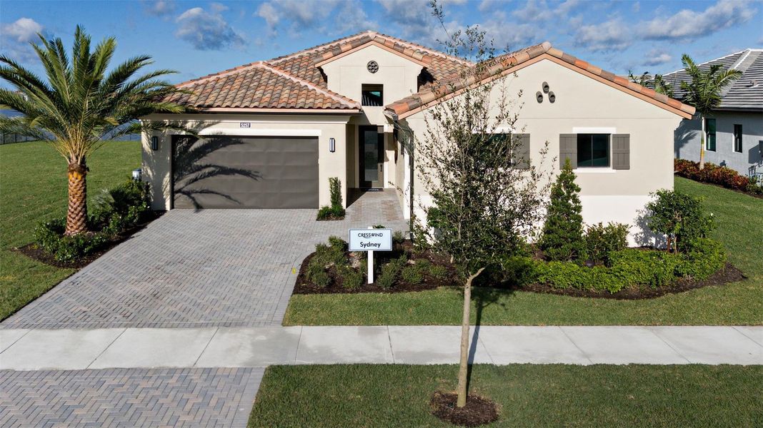Front exterior of a new home in Cresswind Palm Beach at Westlake, Westlake, FL, highlighting curb appeal (Image 2).