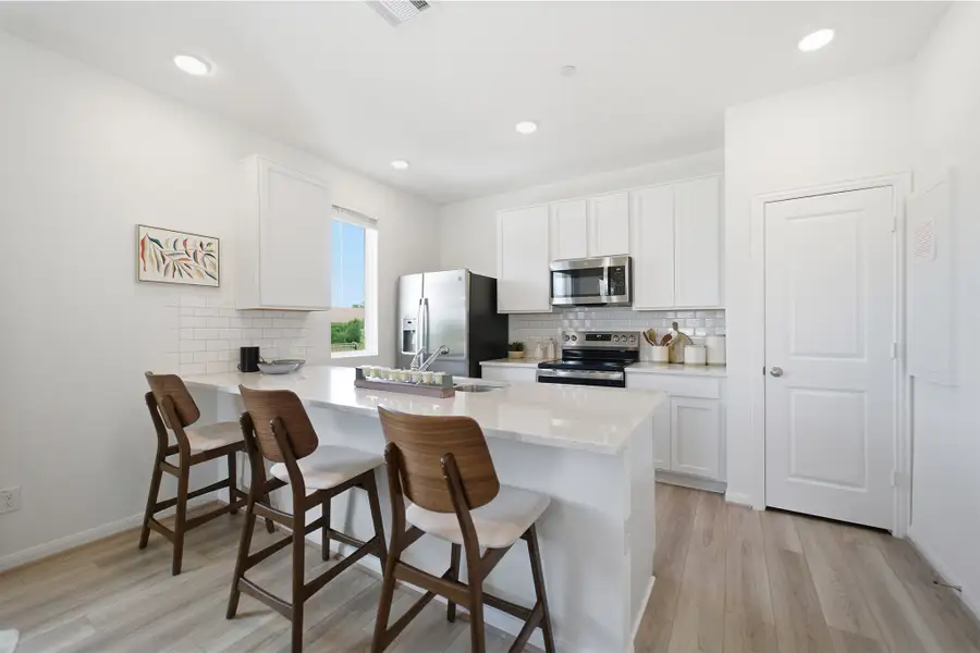 Representative furnished interior of a home built from the Kahn by CastleRock Communities in Municipal Drive Townhomes, Leander (Image 12).