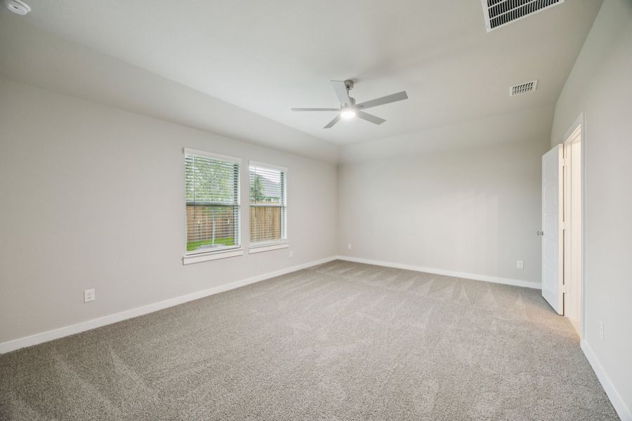 Primary Suite in the Oscar home plan by Trophy Signature Homes – REPRESENTATIVE PHOTO