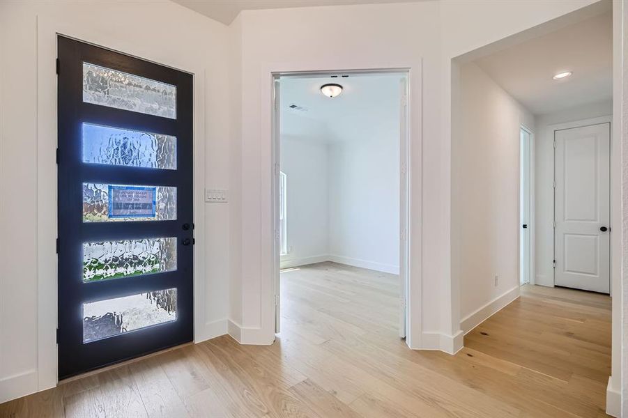 Foyer entrance with light wood-type flooring, baseboards, and recessed lighting Foyer entrance with light wood-type flooring, baseboards, and recessed lighting