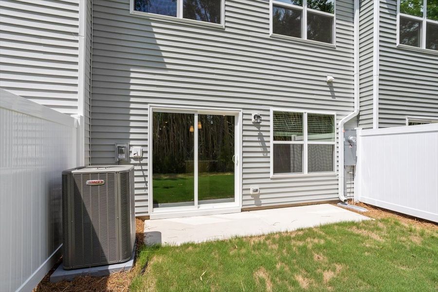 Exterior details and patio area of a home in West Main Townhomes, Sanford (Image 3).