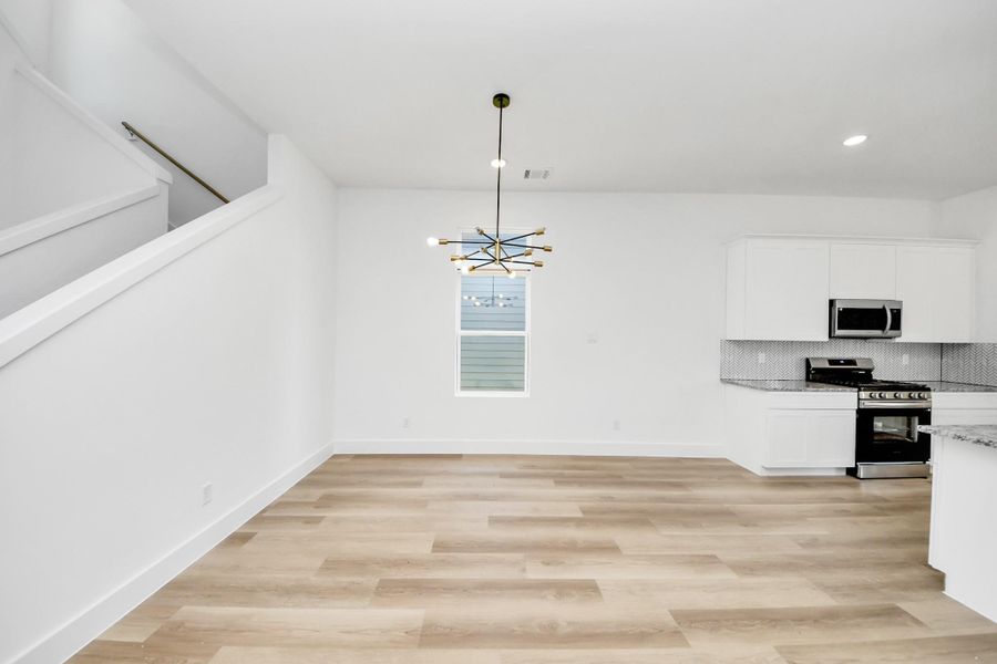 Dining room with natural light and modern light fixture.