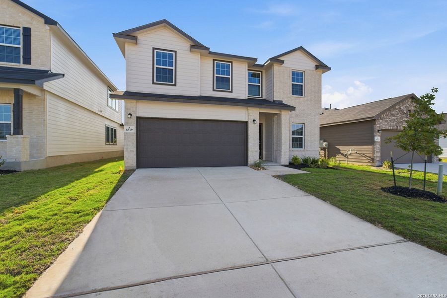 Front exterior of a new home in Morgan Meadows, San Antonio, TX, highlighting curb appeal (Image 21).