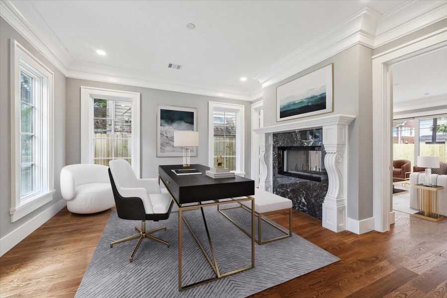 The lovely large formal living room/study/music room is located right off the front foyer and features a double sided fireplace with black marble surround and custom mantle!  Glass doors on both sides can be closed for additional quiet or privacy.   This photo has been virtually staged.